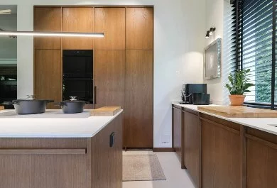 Ciemnodrewniana kuchnia z jasnymi blatami